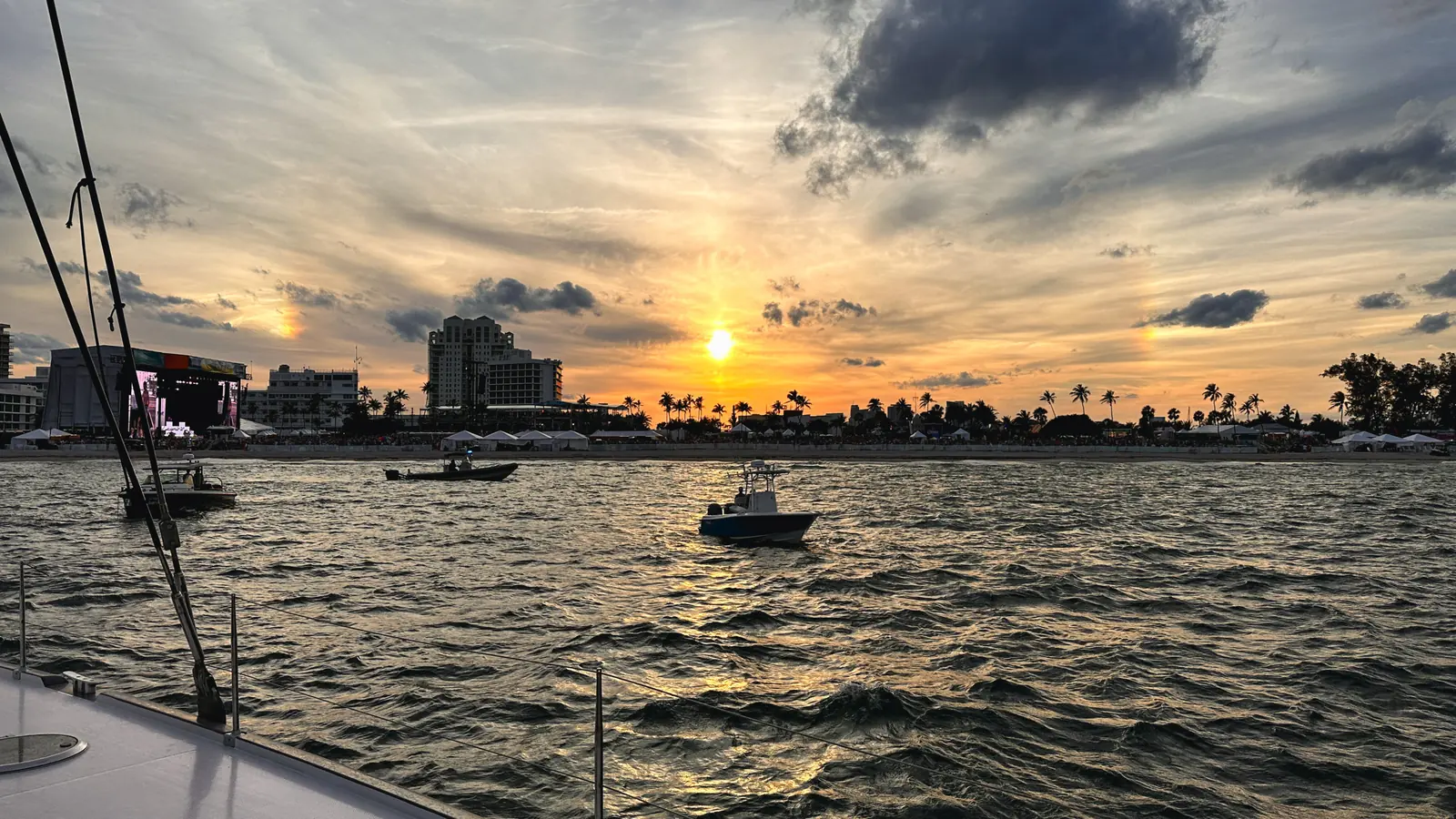 Private boat anchored near a sandbar at sunset
