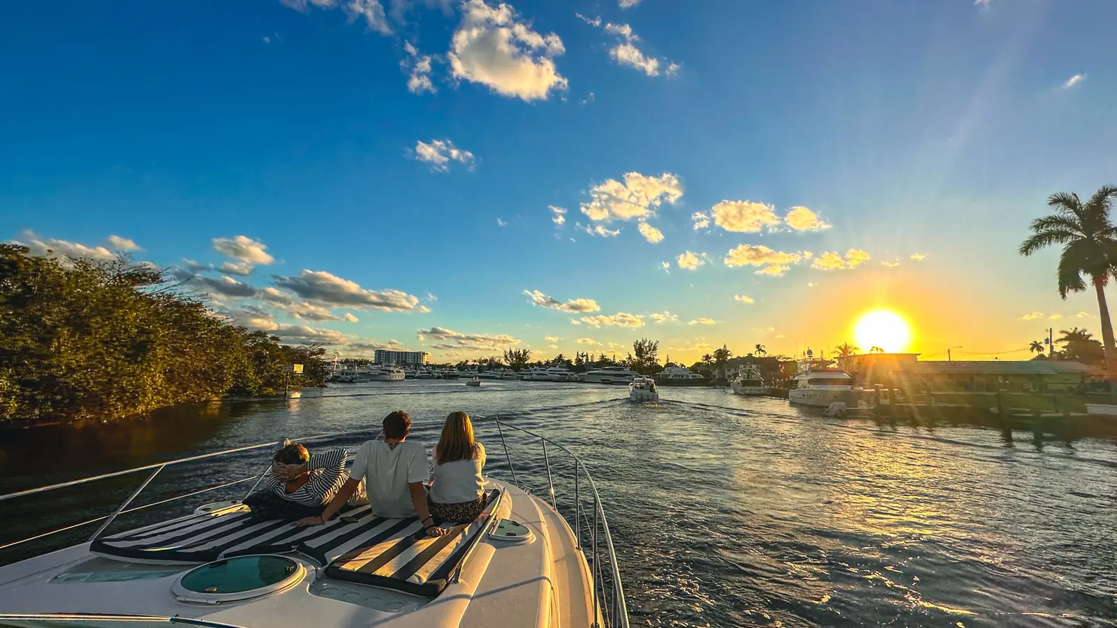 Charter guests watching the sunset from a private boat