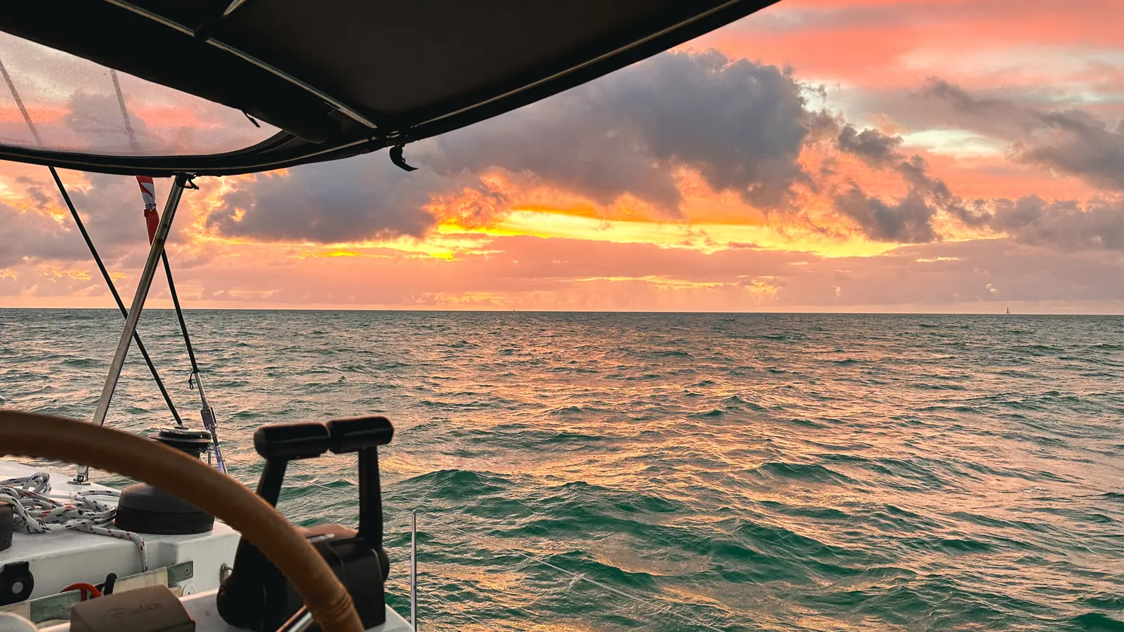 Ocean sunset framed from aboard a private yacht