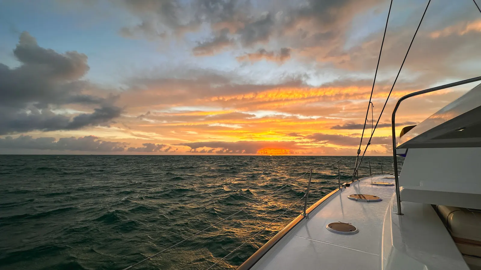 Sailboat silhouetted against a South Florida sunset