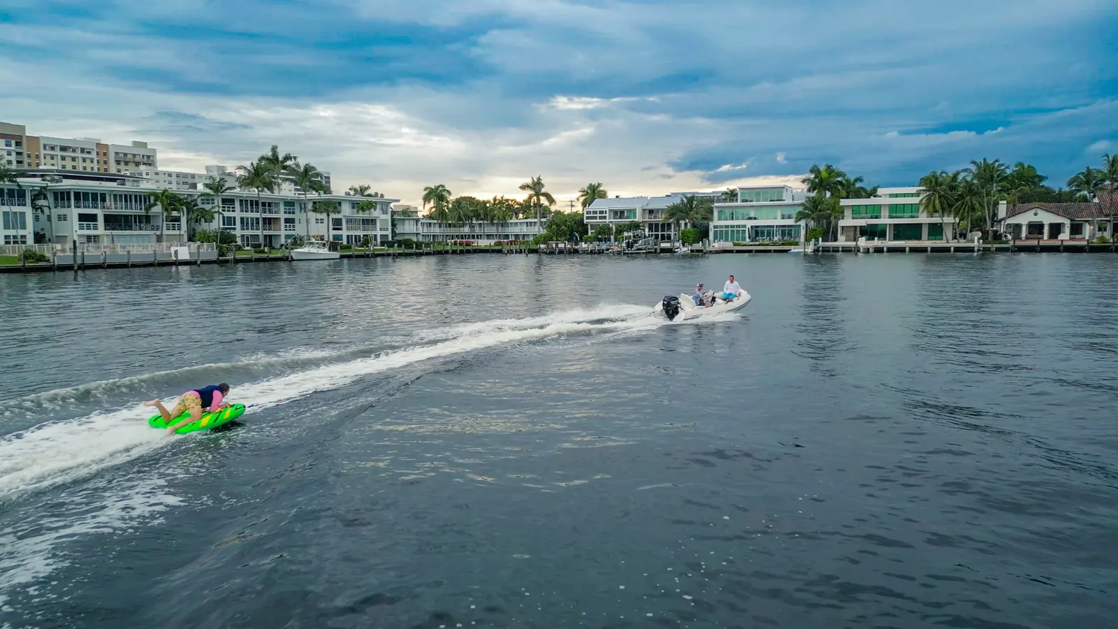 Guests tubing behind a boat during a private charter